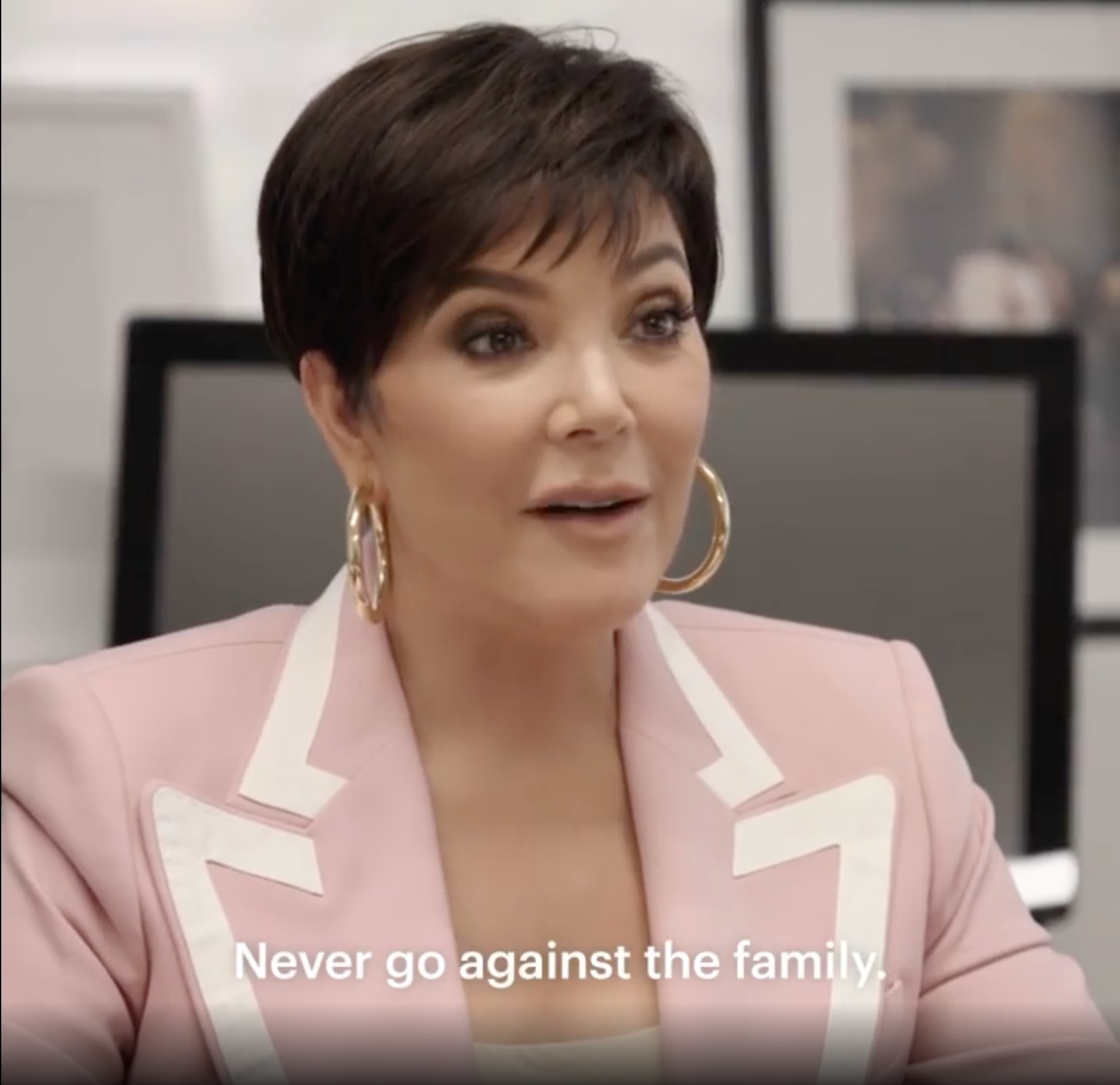 Kris Jenner wearing a pink and white suit