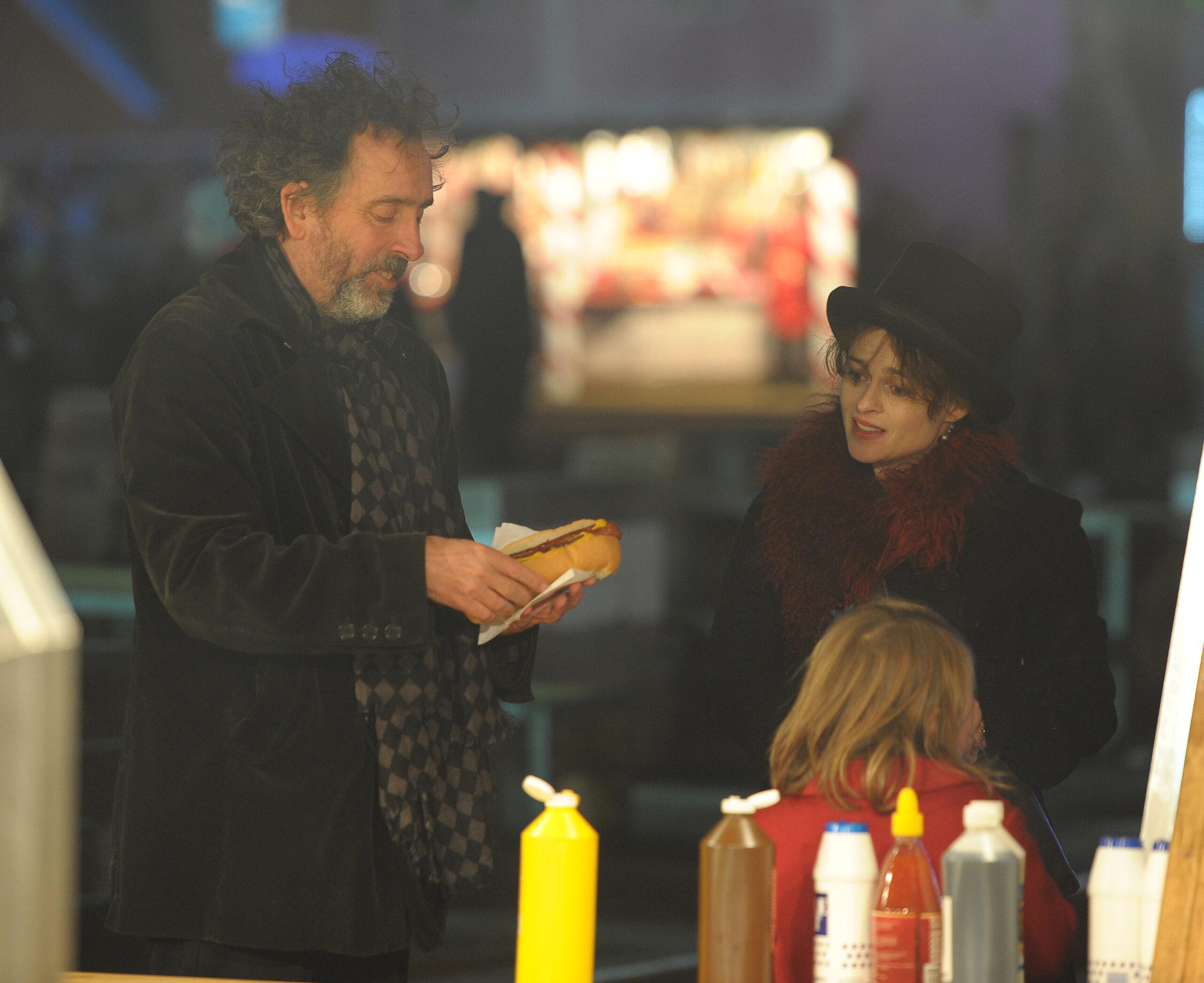Tim Burton and wife Helena Bonham Carter visit Winter Wonderland held in Hyde Park The film director was seen tucking into a hot dog