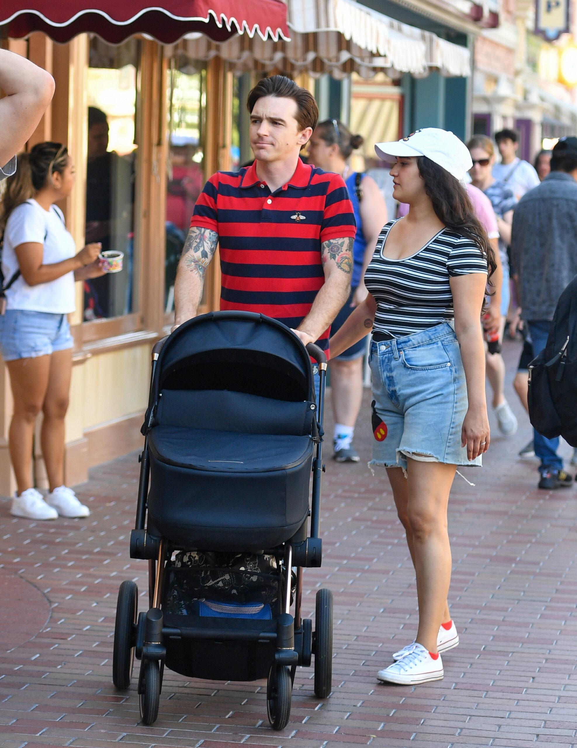 Drake Bell is seen for the first time since pleading guilty to child endangerment with a women who is believed to be his wife and a baby at Disneyland The actor was seen celebrating his 35th birthday with his little family putting his legal woes behind