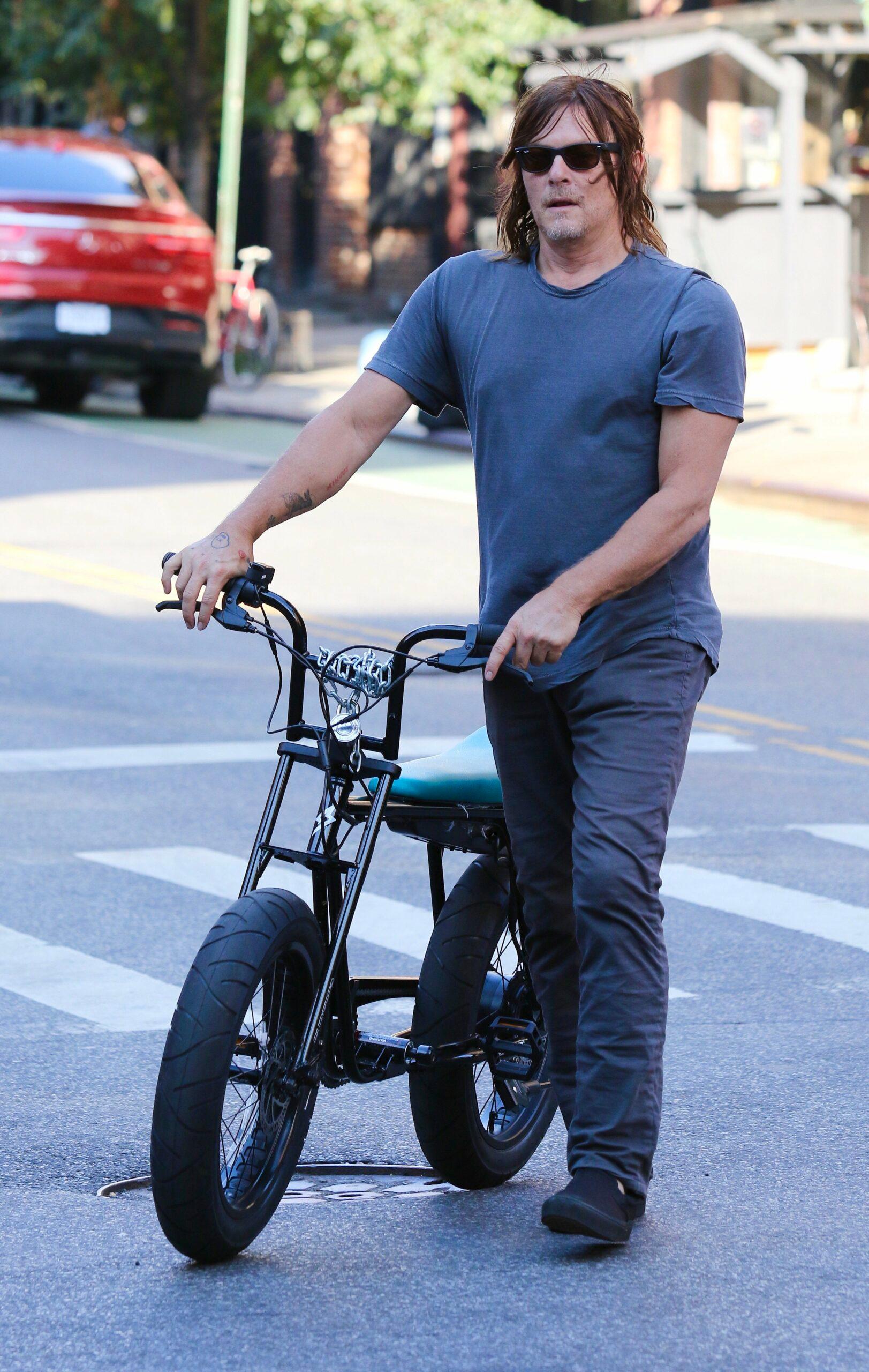 Norman Reedus walks home after a bike ride in NYC