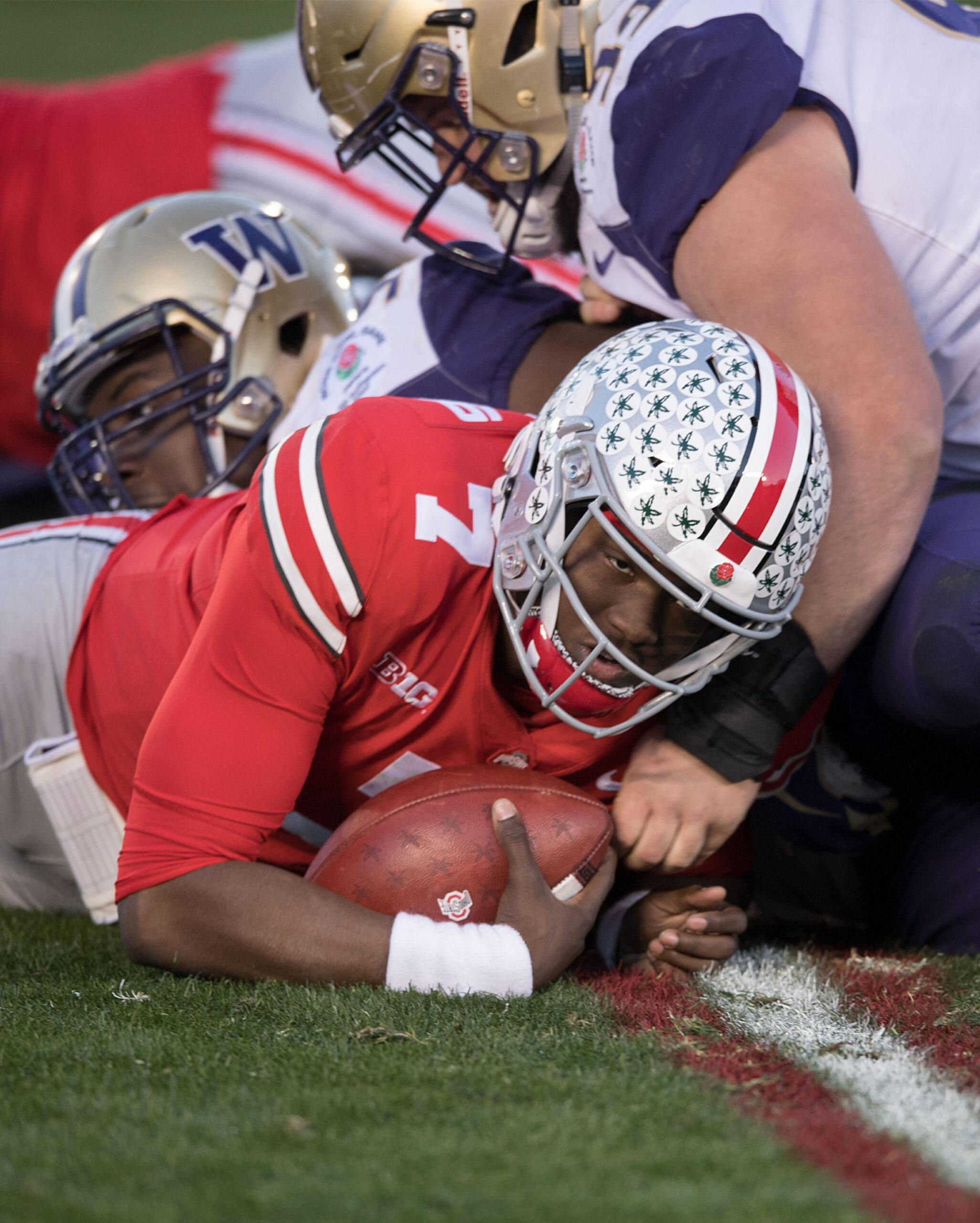 1 Johnnie Dixon, WR of the Ohio State Buckeyes is blocked by defender of the Washington Huskies during the 105th Rose Bowl Game held at the Rose Bowl Stadium in Pasadena, California on Tuesday January 1, 2019. 01 Jan 2019 Pictured: 7 Dwayne Haskins, QB of the Ohio State Buckeyes passes the ball during their game with the Washington Huskies at the 105th Rose Bowl Game held at the Rose Bowl Stadium in Pasadena, California on Tuesday January 1, 2019. Photo credit: ZUMAPRESS.com / MEGA TheMegaAgency.com +1 888 505 6342 (Mega Agency TagID: MEGA331120_015.jpg) [Photo via Mega Agency]