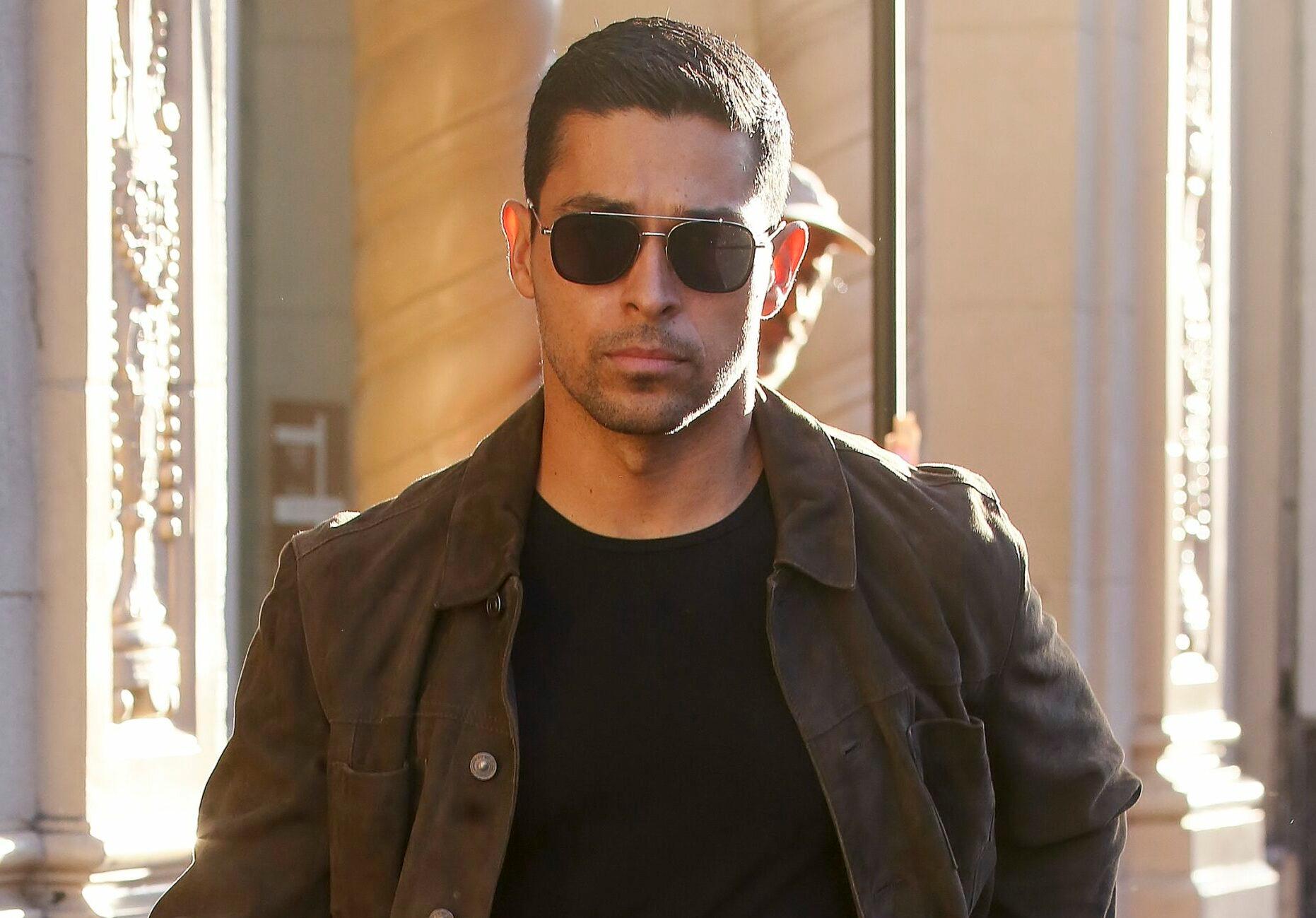 Wilmer Valderrama gives the peace sign while going to the "The Art Of Racing In The Rain" premiere