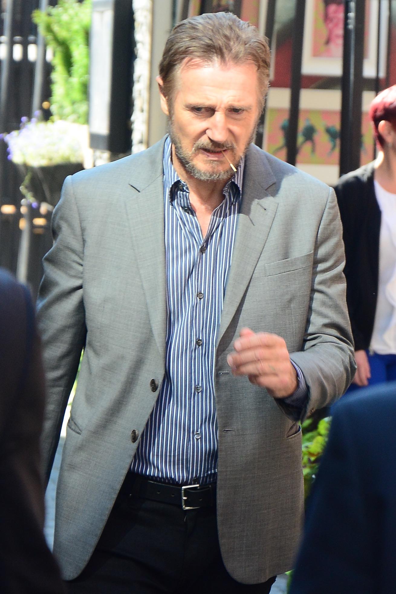 A slim oooking Liam Neeson leaves Tiff event