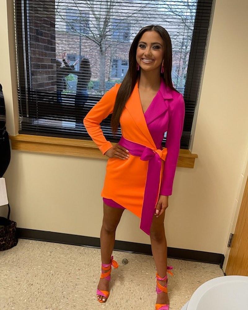 Kailia Posey in orange and pink dress