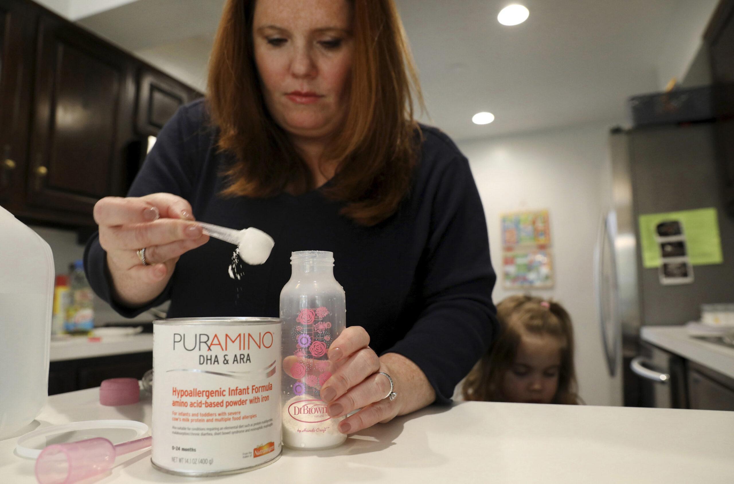 Ashley Strom prepares a bottle of PurAmino formula for her daughter Chloe, 7 months, at their home in Northbrook, Illinois, on Thursday, May 5, 2022. Strom uses PurAmino due to a Chloe&apos;s dairy intolerance, but because of a shortage of formula, it&apos;s been difficult for Ashley and other parents to acquire the necessary products.