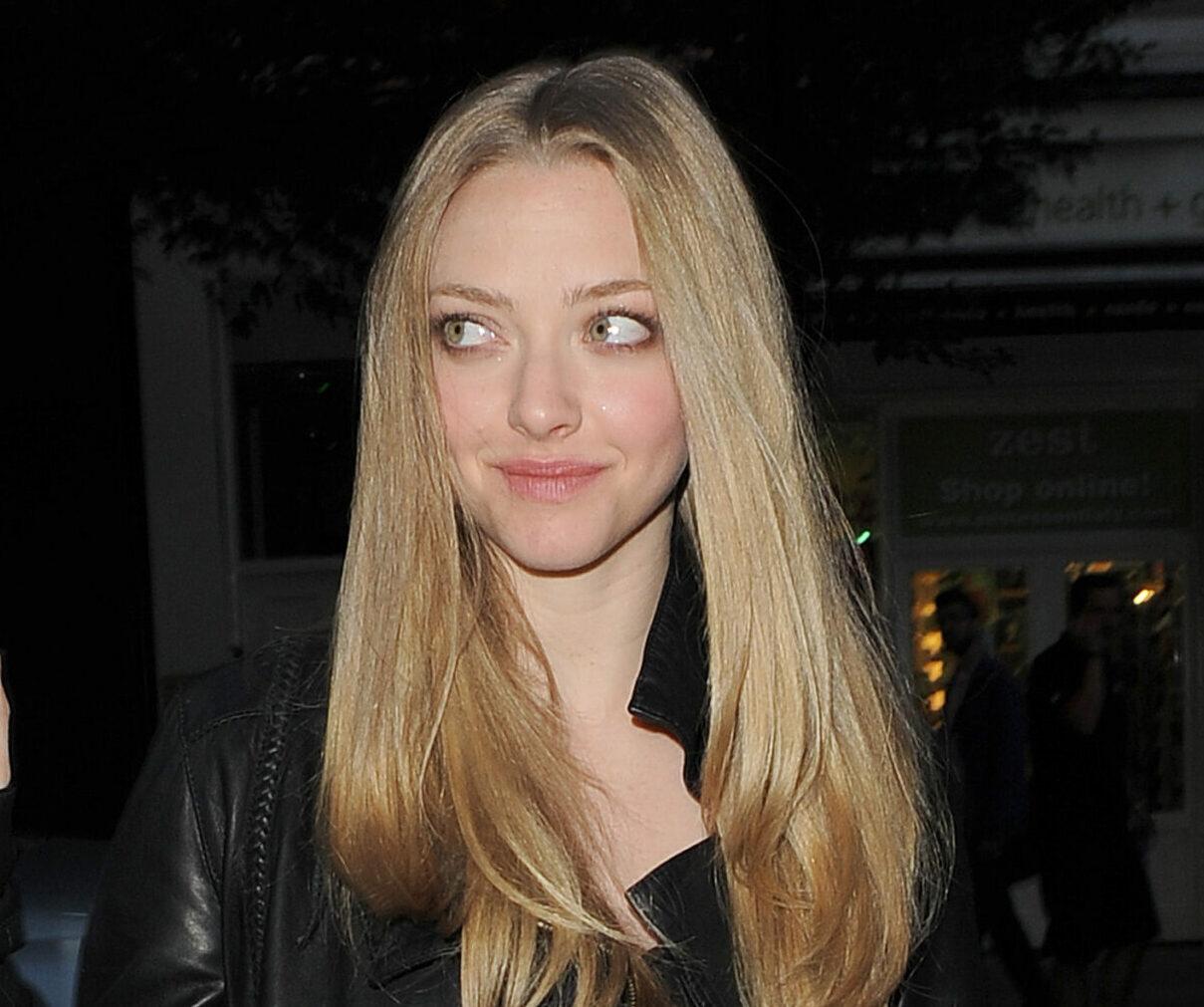 Amanda Seyfried arriving at Yauatcha restaurant in Soho The actress wore a black leather jacket black t-shirt jeans and orange high heels