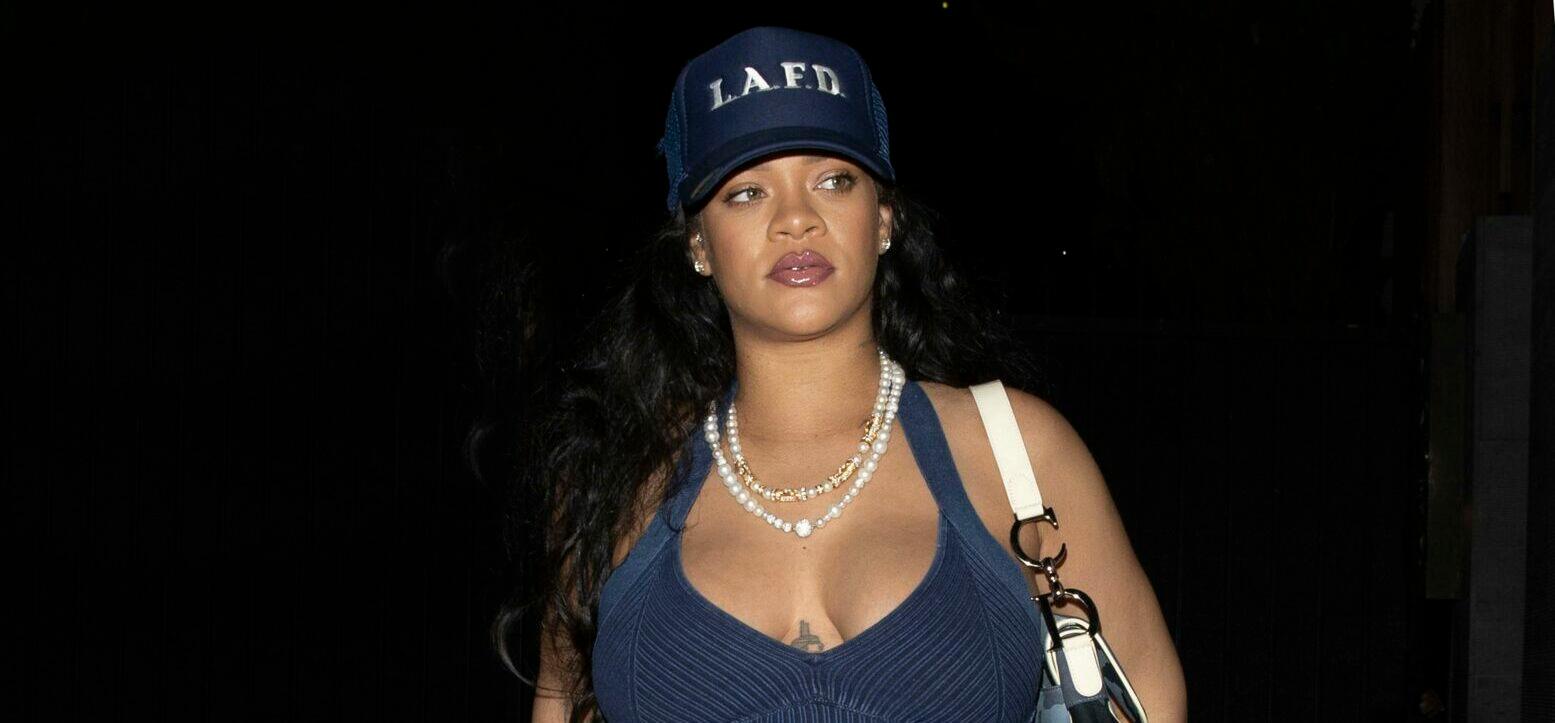 Rihanna shows off her huge baby bump while wearing denim and an LAFD hat at Nobu in West Hollywood