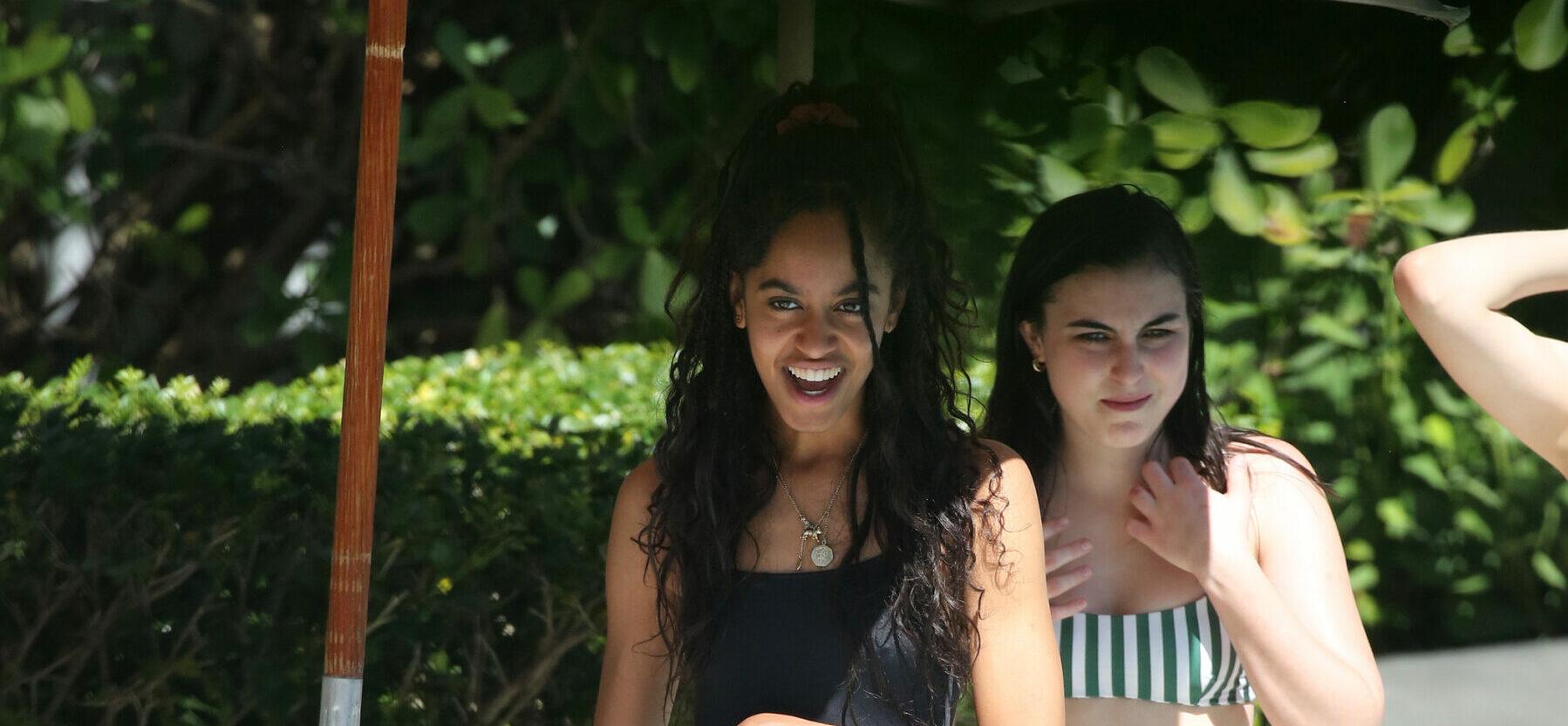 20 year old former First Daughter Malia Obama wears a black swimsuit as she drinks wine with friends by the pool in Miami. 17 Feb 2019 Pictured: Malia Obama. Photo credit: MEGA TheMegaAgency.com +1 888 505 6342 (Mega Agency TagID: MEGA361609_012.jpg) [Photo via Mega Agency]