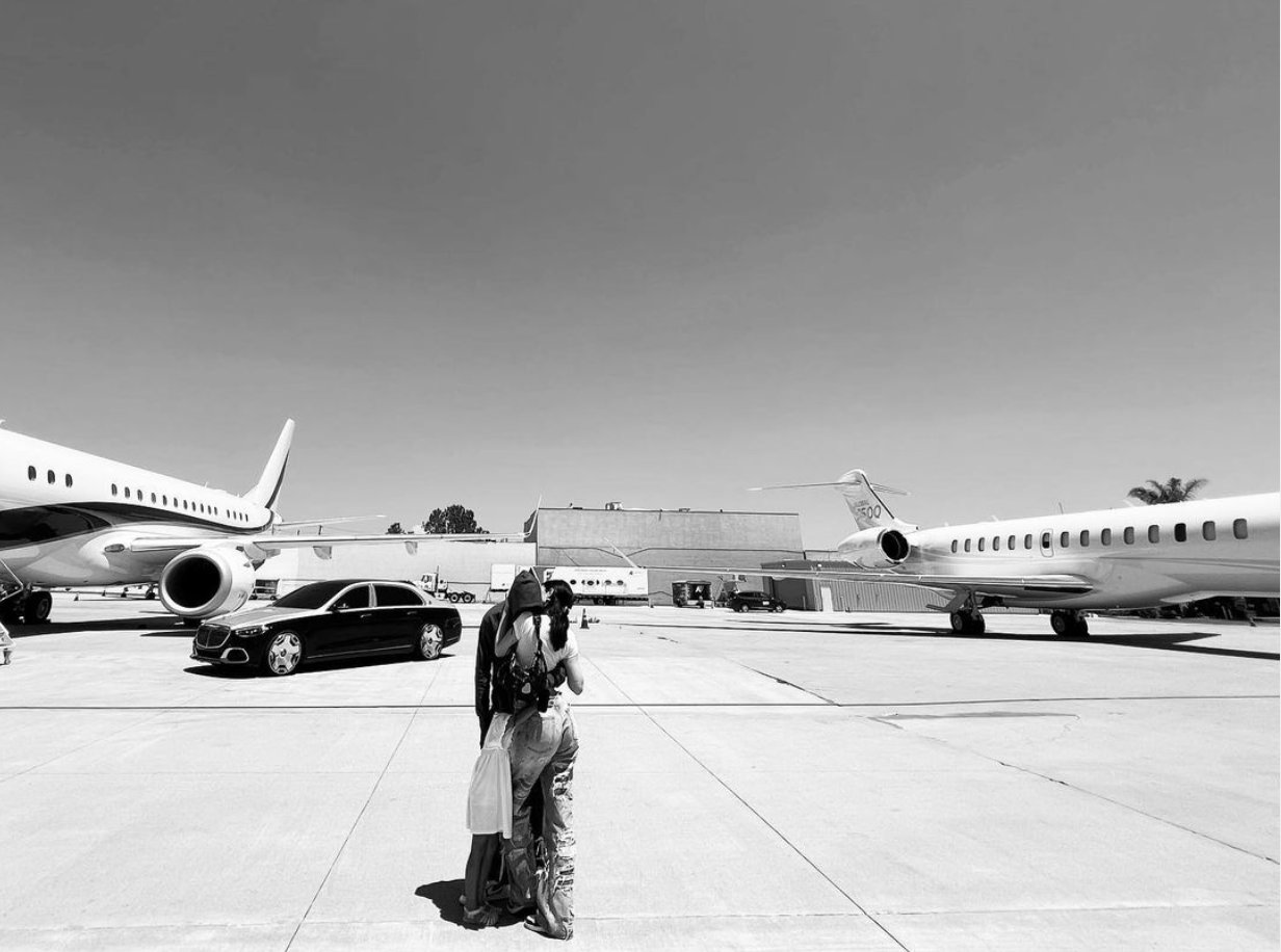 Kylie Jenner & Travis Scott in front of their private jets