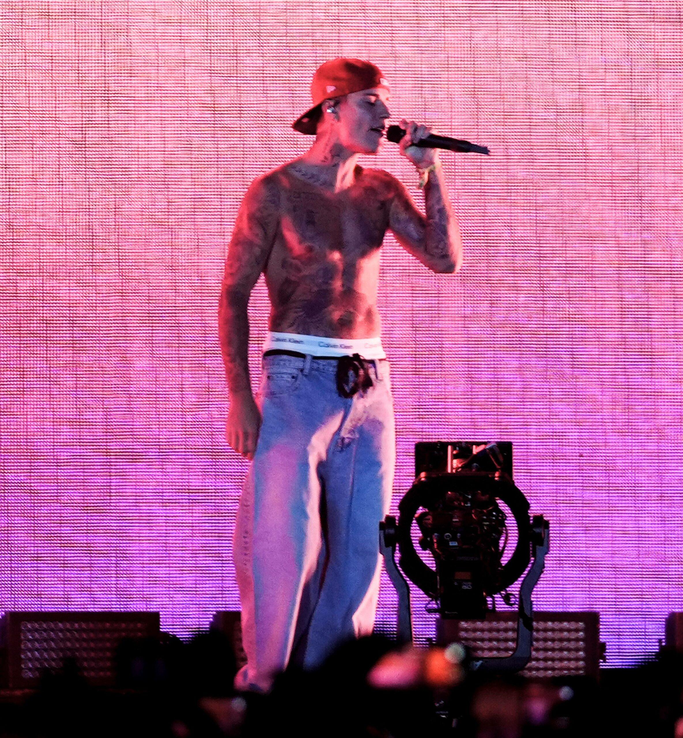 Justin Bieber performs shirtless with Justin Caesar at the Coachella Music Festival in Indio, California.