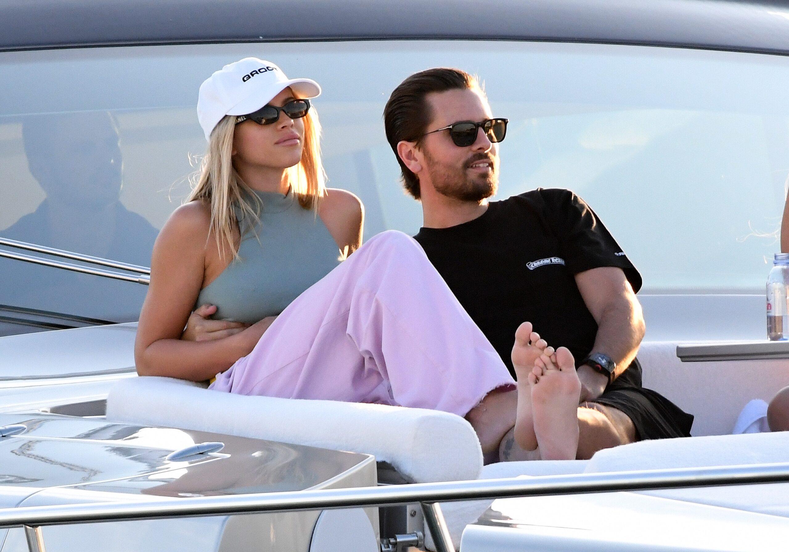 Scott Disick wraps his arms around girlfriend Sofia Richie as they watch the sunset from a yacht in Miami