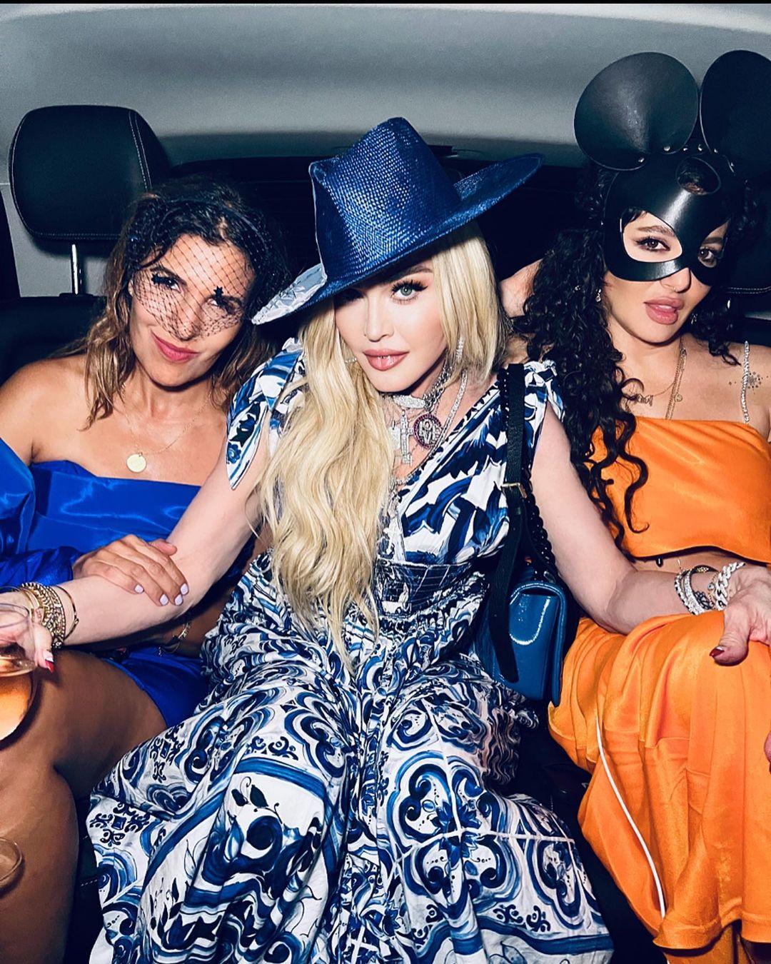 Madonna sitting in between two women