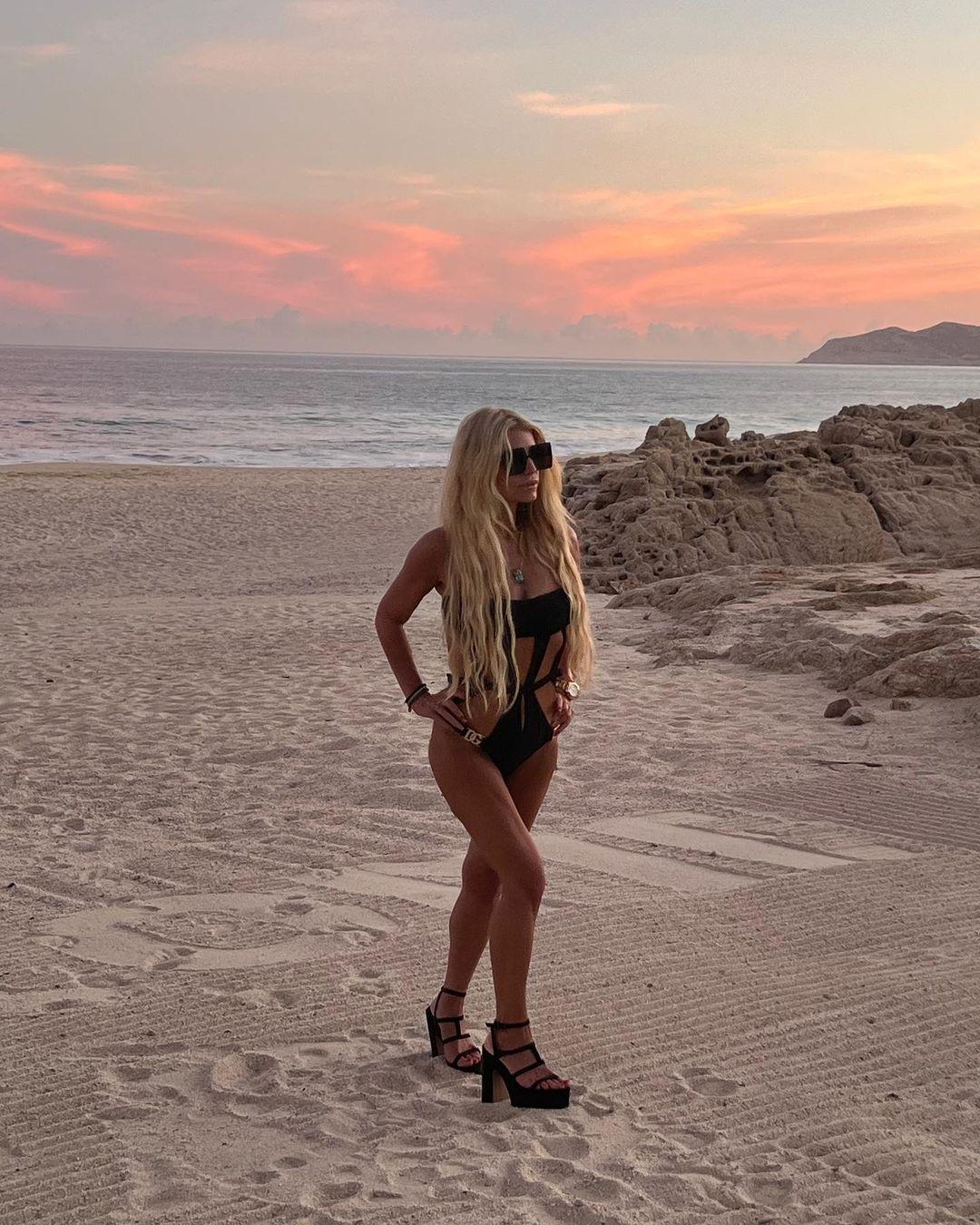 Jessica Simpson looks stunning in a black cutout swimsuit