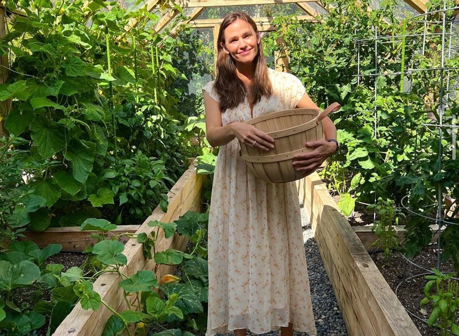Jennifer Garner with a basket surrounded by her garden.
