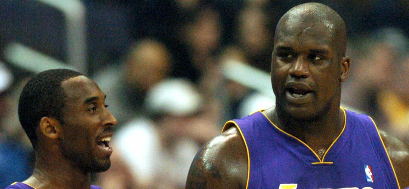 Kobe Bryant and Shaquille O'Neal talk during a timeout against Washington on Saturday, February 28, 2004