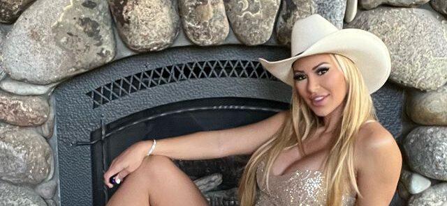 Kindly Myers in a cowboy hat and sheer dress
