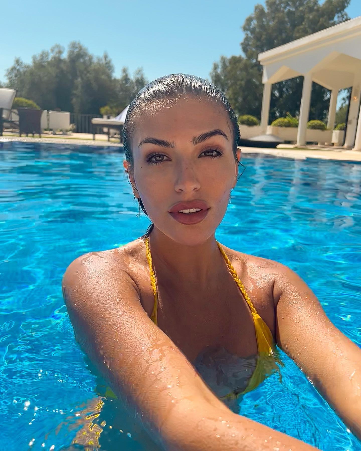 Emily Faye Miller visits a pool party in a yellow bikini