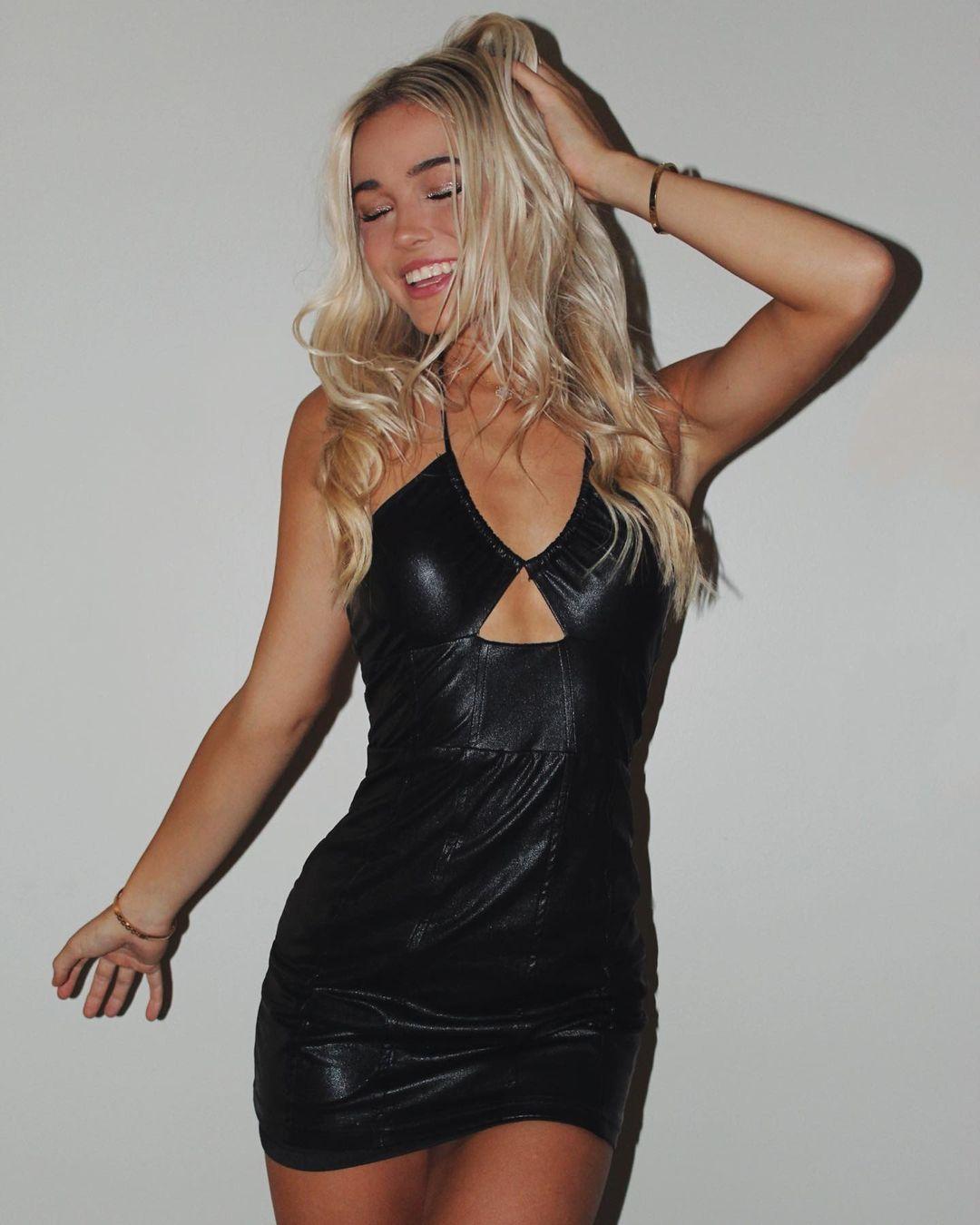 Olivia Dunne poses in her black leather dress.