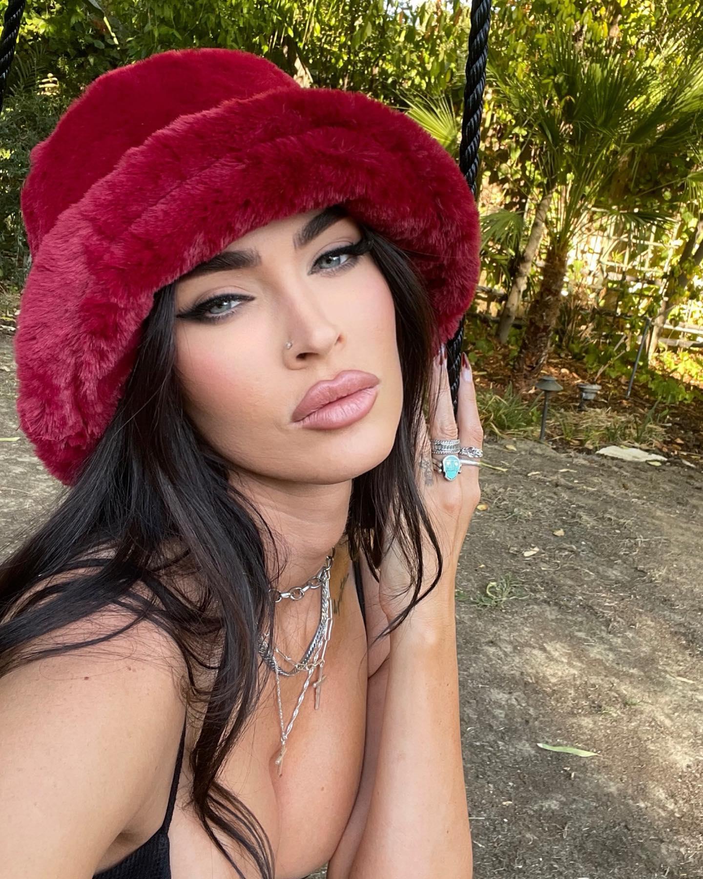 Megan Fox shares a selfie in a black top and red hat
