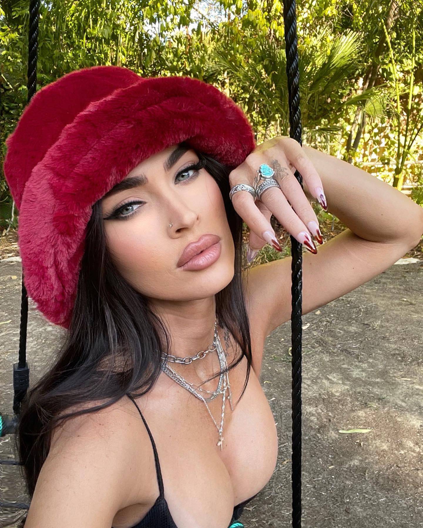 Megan Fox shares a selfie in a black top and red hat