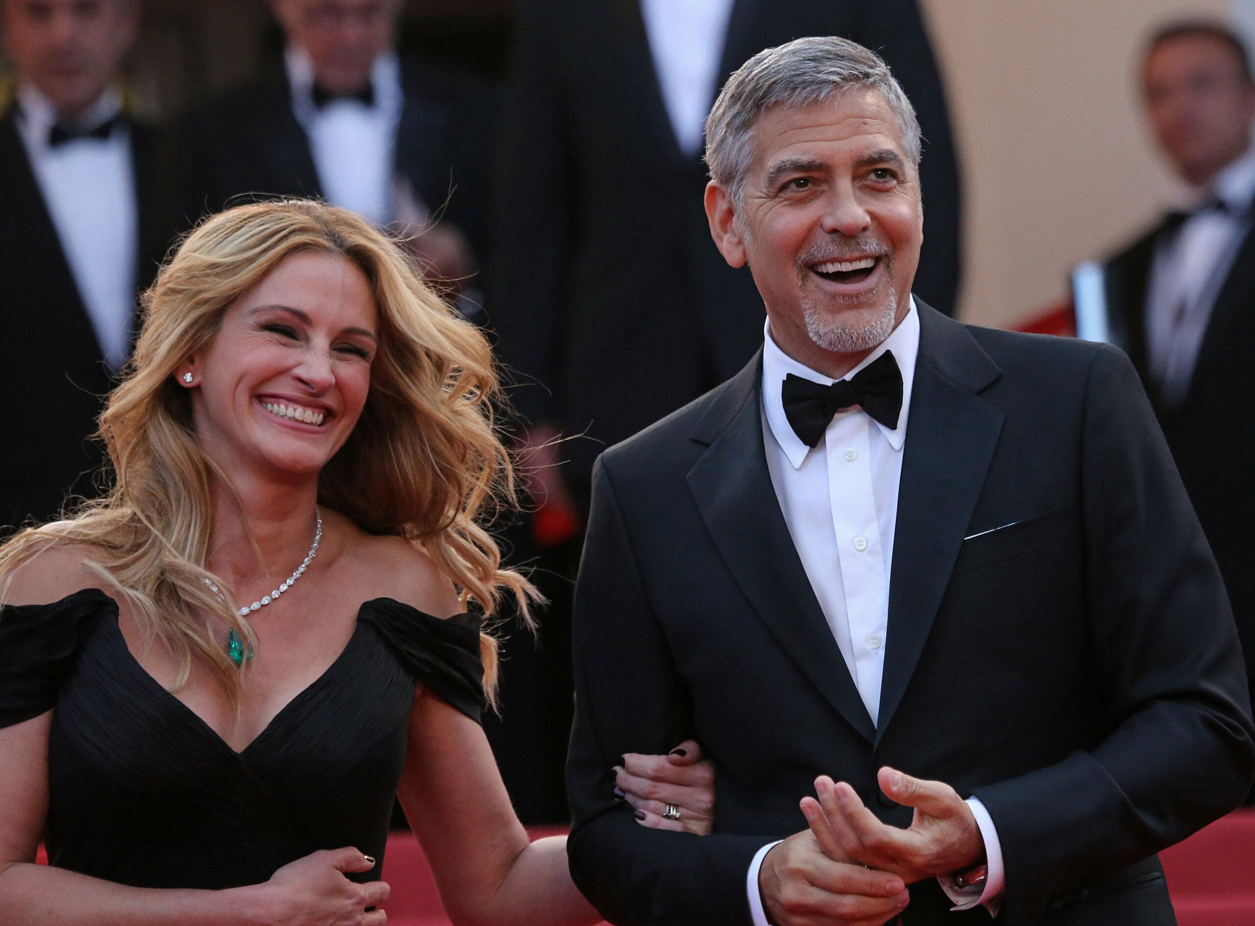 Julia Roberts and George Clooney arrive on the steps of the Palais des Festivals before the screening of the film "Money Monster" during the 69th annual Cannes International Film Festival in Cannes, France on May 12, 2016. 