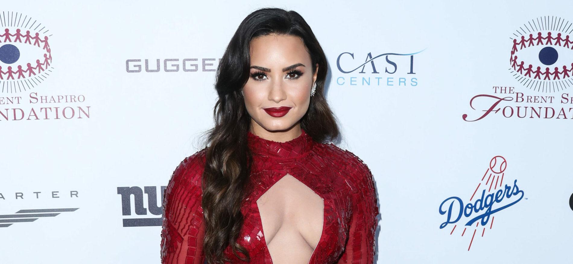 Demi Lovato at an event in a red dress