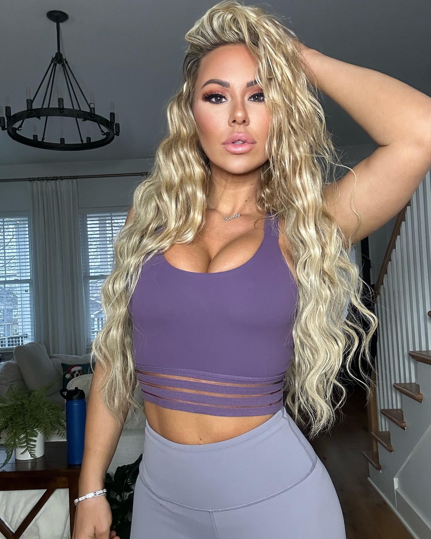 Kindly Myers shows off her new hair and a new outfit: a purple sports bra and gray CNC leggings