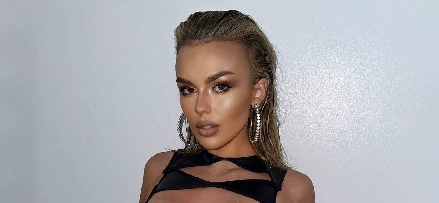 Tallia Storm in a black cut-out outfit