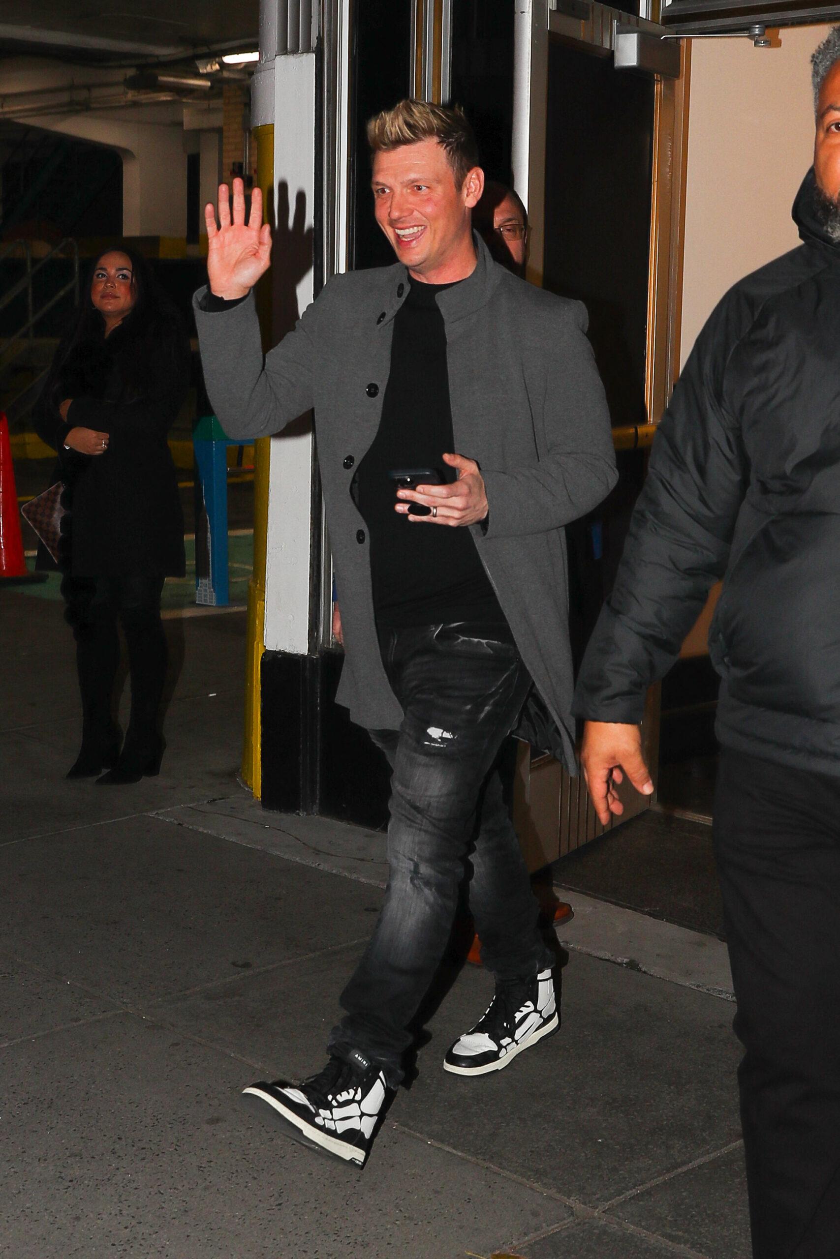 Nick Carter is all smiling on the day he was sued for Alleged Rape of 17-Year-Old Girl On Tour Bus Nick waves at his fans outside the Empire State Building in New York City