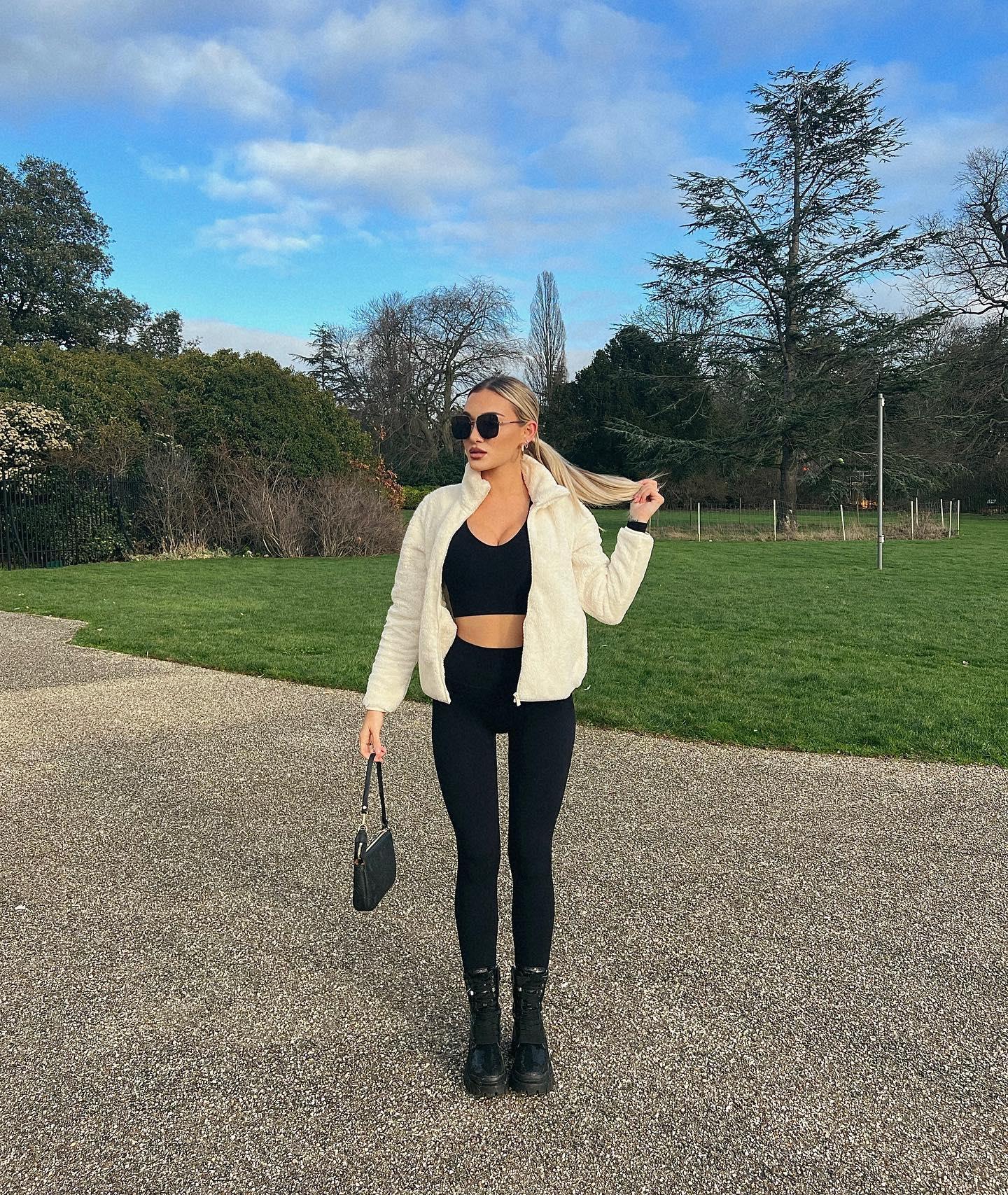 Beaux Raymond in a black crop top and white jacket