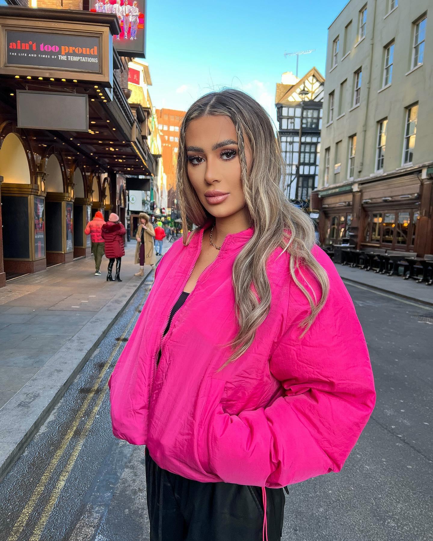 Demi Sims in a pink jacket