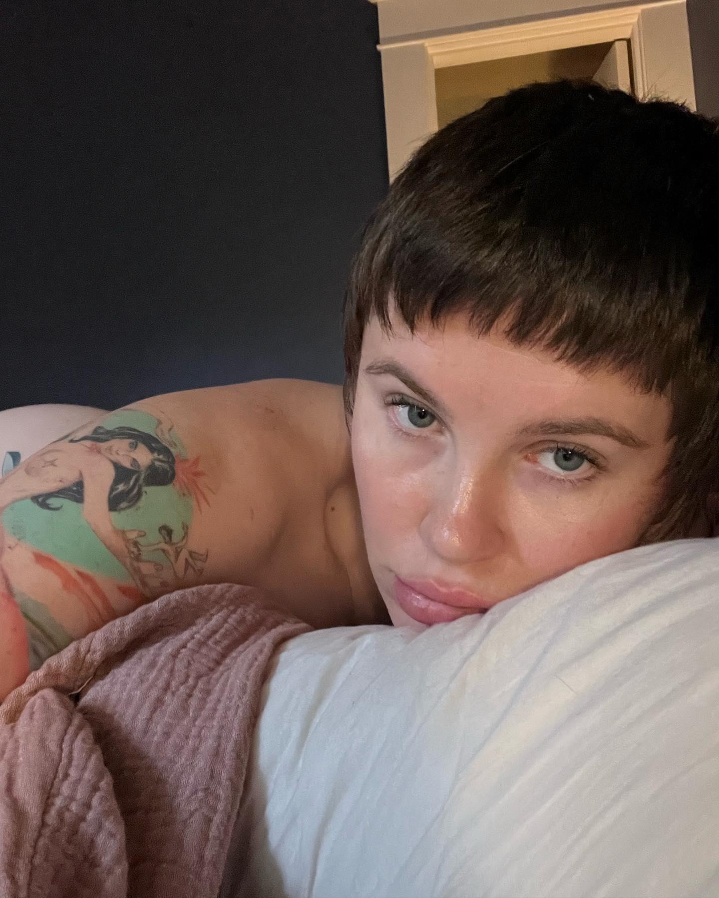Ireland Baldwin hides her pregnant belly in topless selfies