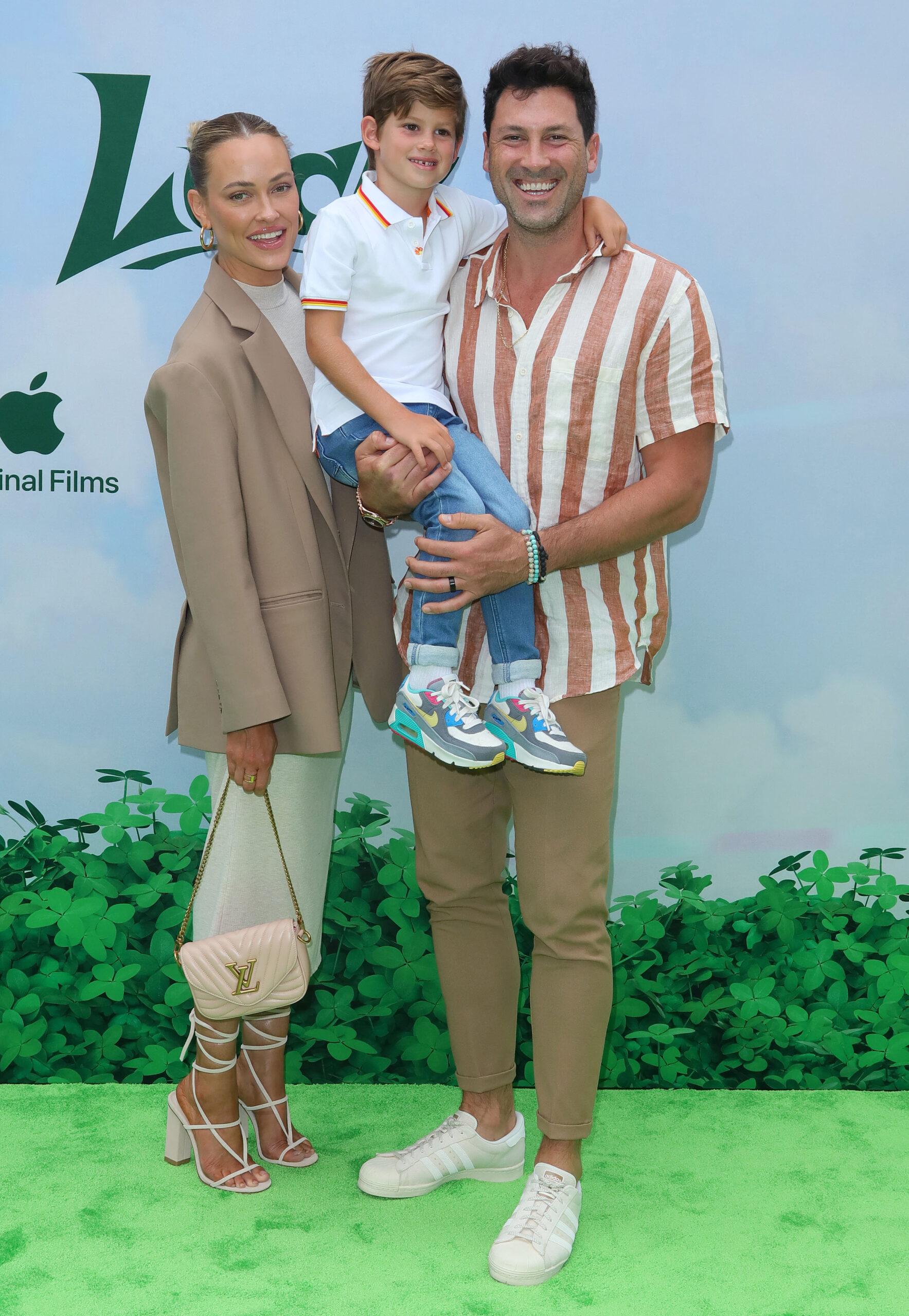 Peta Murgatroyd, Maksim Chmerkovskiy and their son at Red Carpet Event for the global premiere of Apple Original Film LUCK in Los Angeles