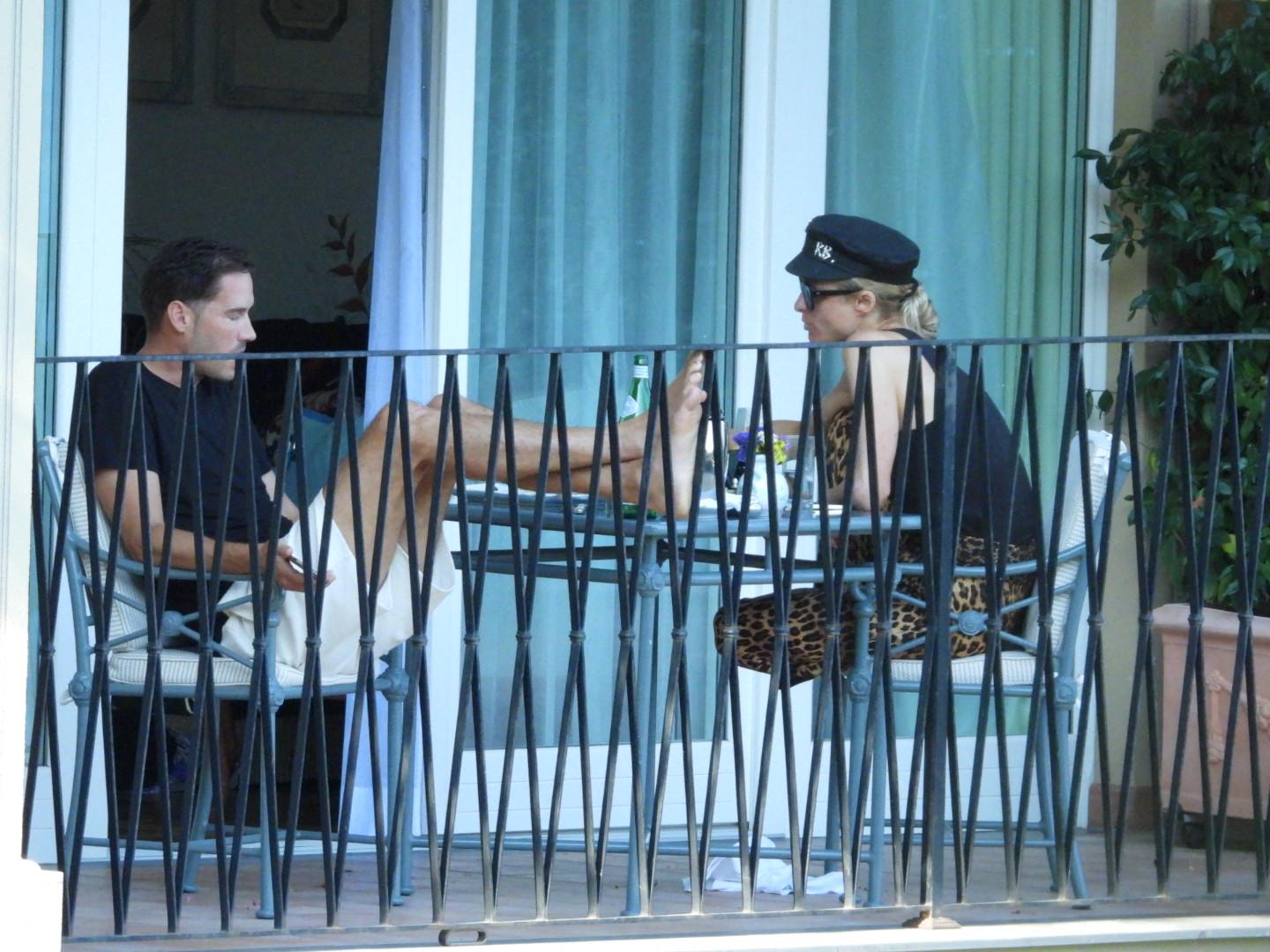 Paris Hilton and husband Carter Reum are seen relaxing on the terrace of their hotel in Portofino