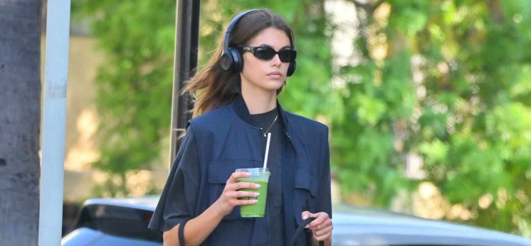 Kaia Gerber stops by a cafe for an iced Matcha while out with her dog