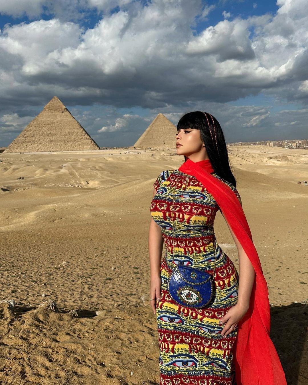Demi Rose striking a pose in front of a pyramid in Egypt.