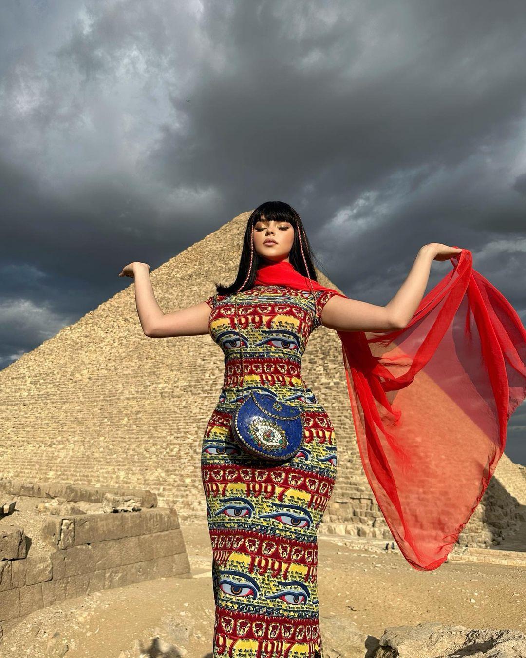 Demi Rose striking a pose in front of a pyramid in Egypt.