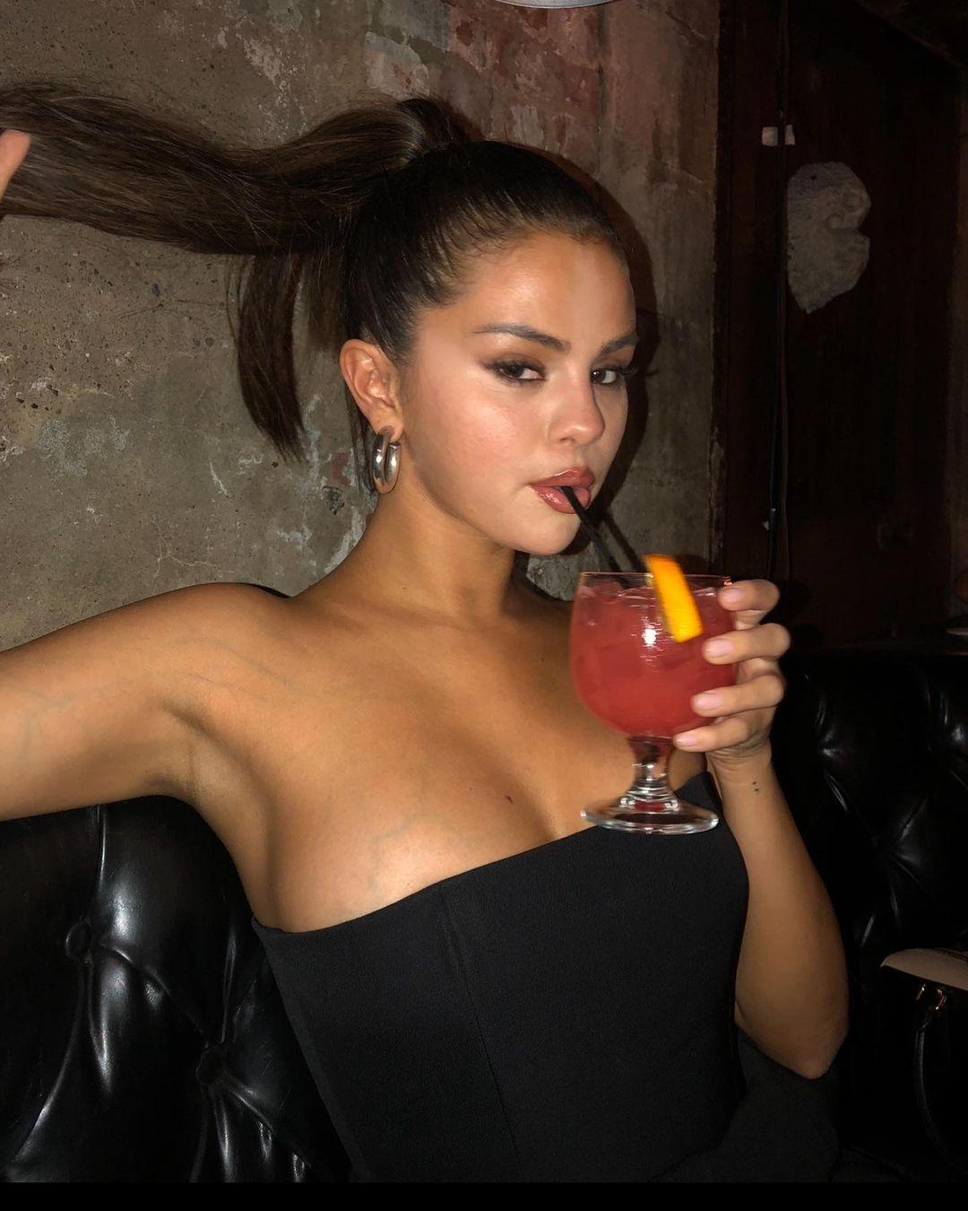 Selena Gomez drinking.