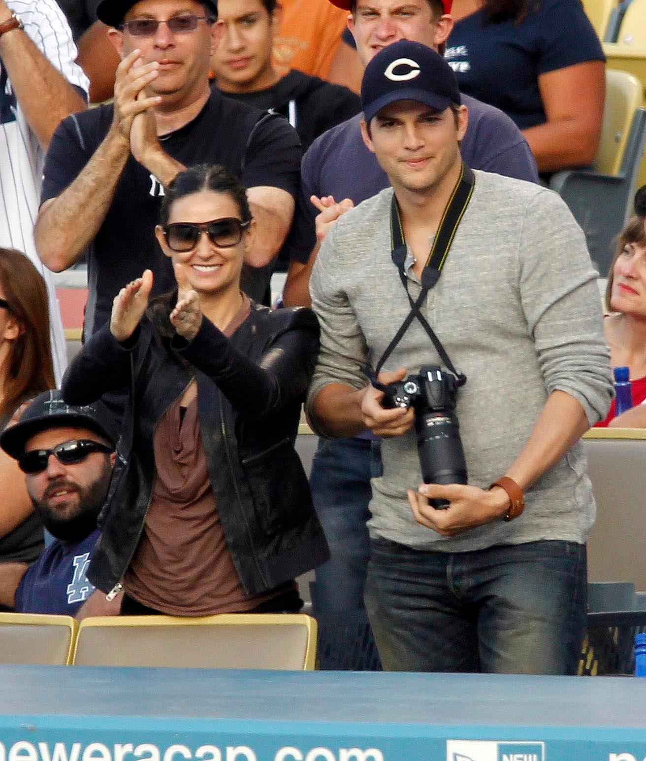Demi Moore and Ashton Kutcher cheer on a homerun by Yankees Alex Rodriguez