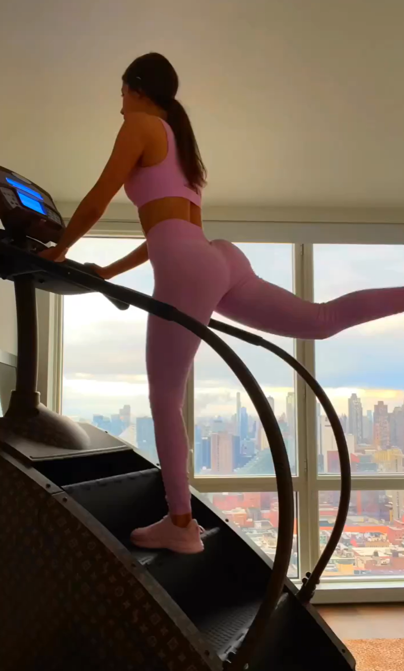 Jen Selter on her stair climber in pink leggings