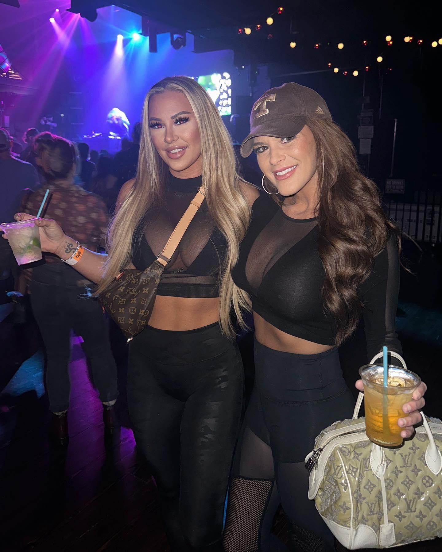 Kindly Myers and a friend accidentally twin in a black see-through shirt