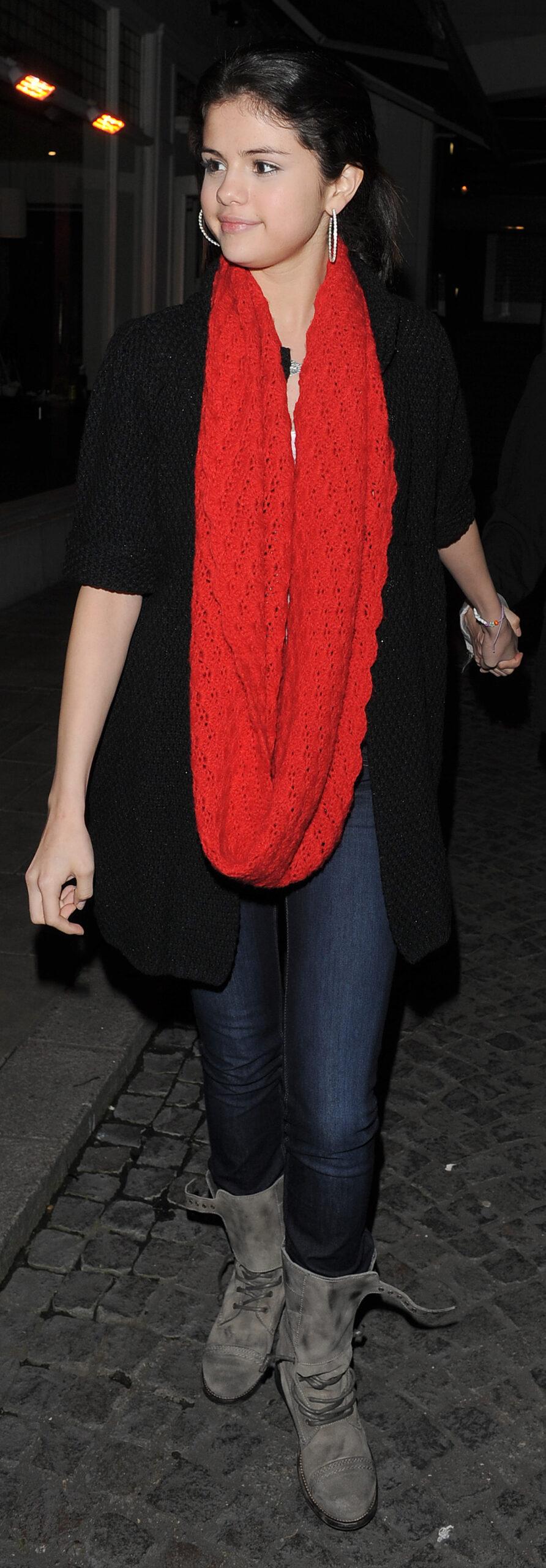 American actress and singer Selena Gomez leaving the Bluebird Cafe in Chelsea having had dinner there with her mother Mandy Gomez and friends Selena wore a white t-shirt black cardigan grey boots and a huge red scarf