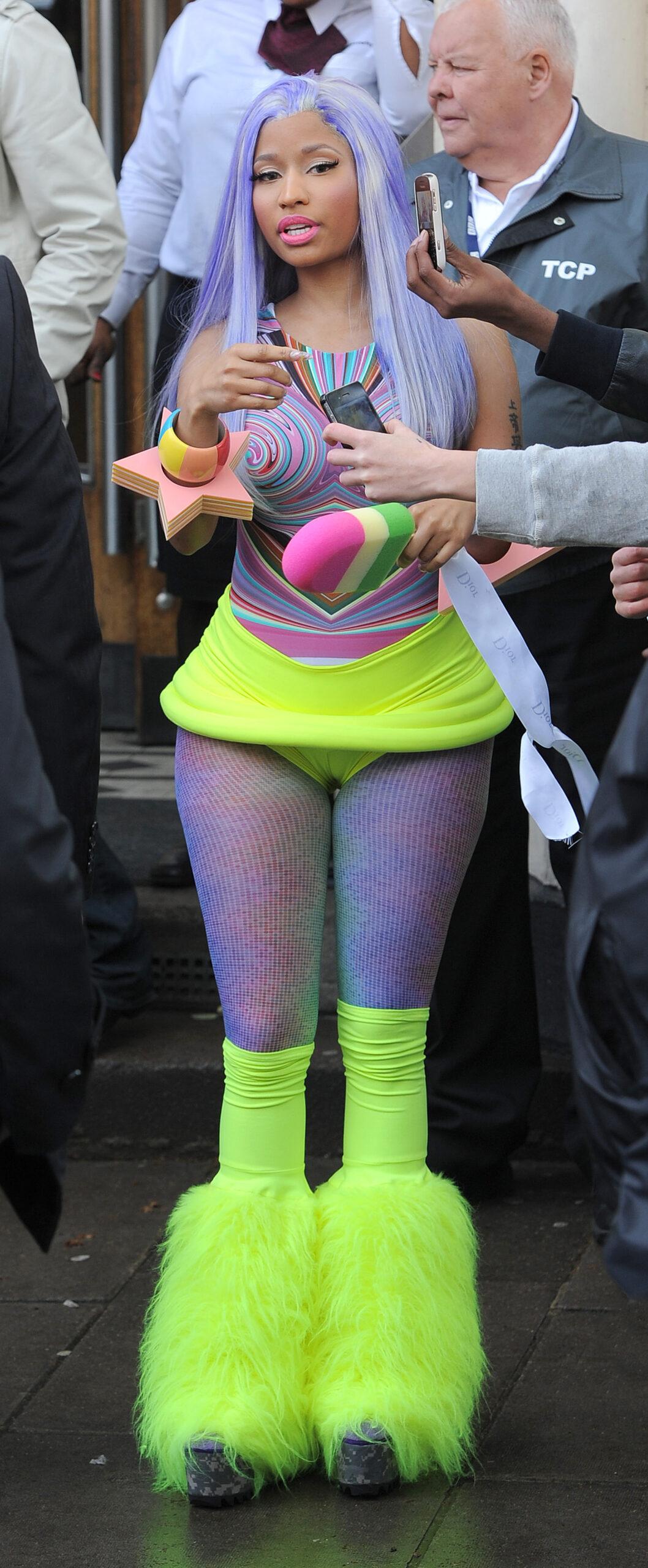 Nicki Minaj leaving the BBC Maida Vale studios The singer showed off her new blue hair and wore a multicoloured top neon yellow hot pants tights and neon yellow boots