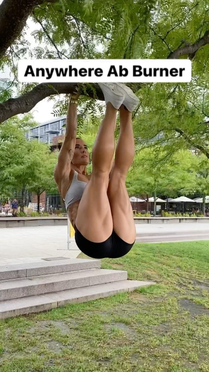 Senada Greca hanging from a tree in ab workout