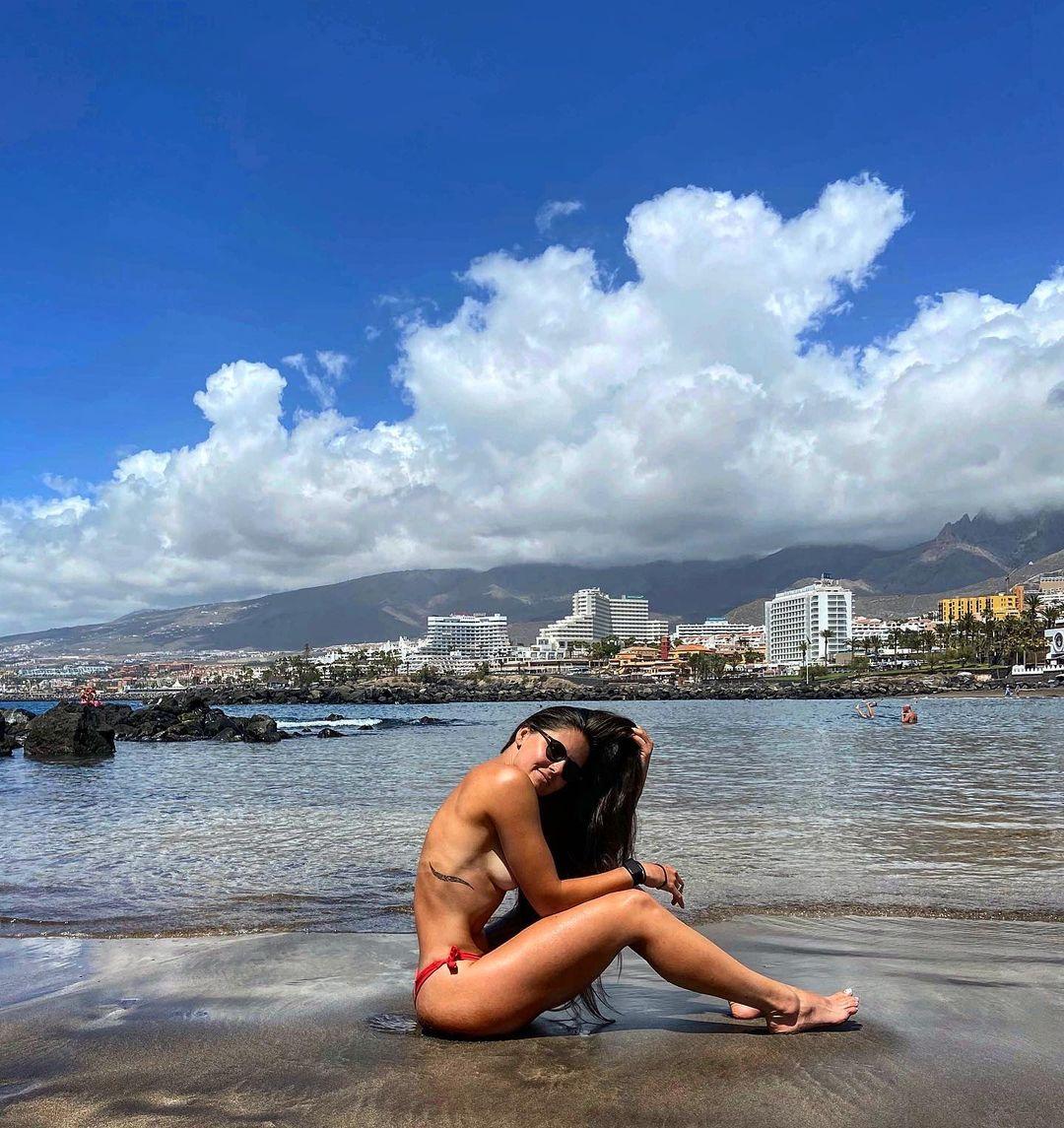 Alexandra Ianculescu basking in the sun at the beach.