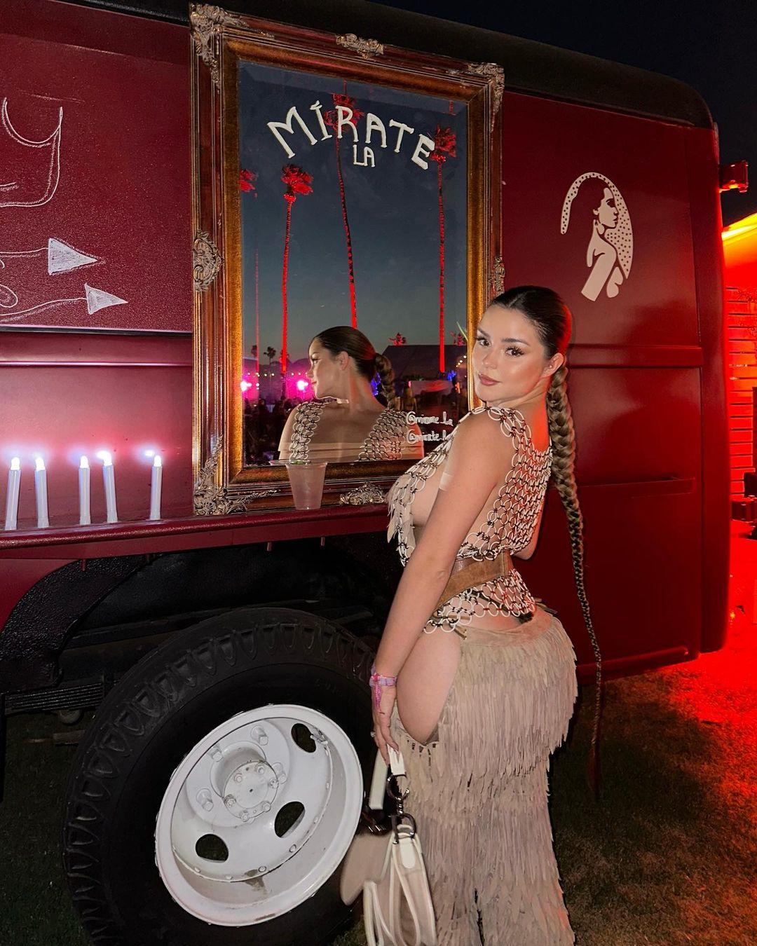 Demi Rose showing a rear view of her Coachella attire.