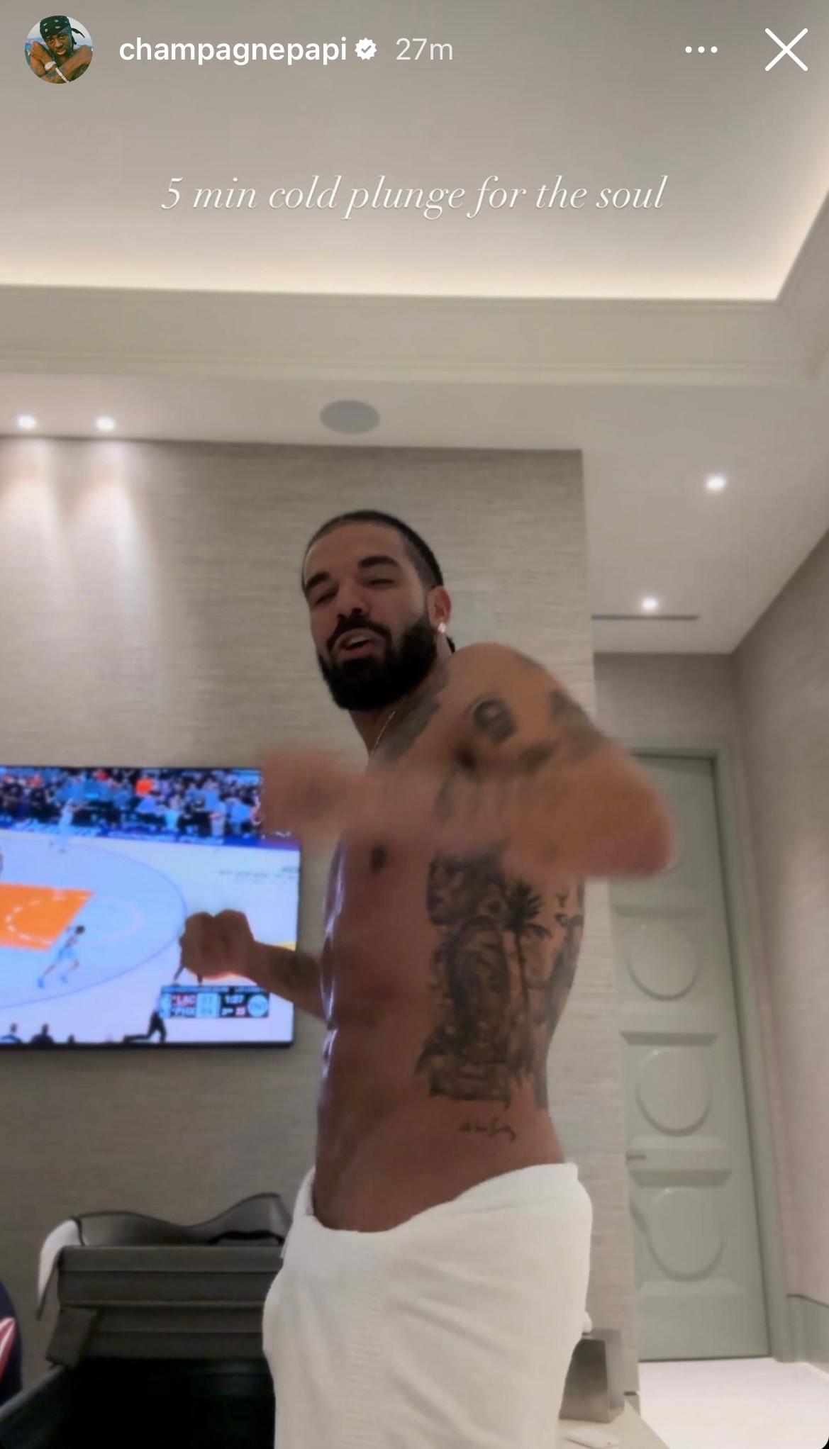 Drake flaunts washboard abs in a dangerously low towel