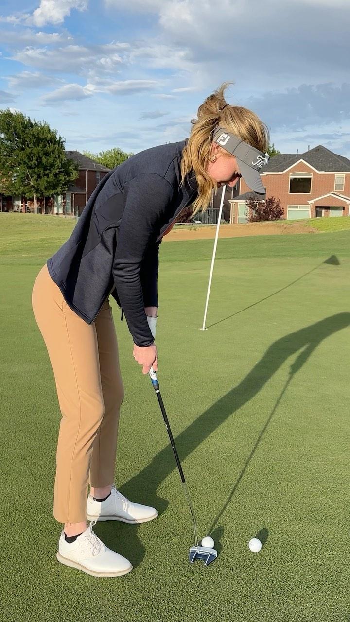 Grace Charis plays golf in a jacket