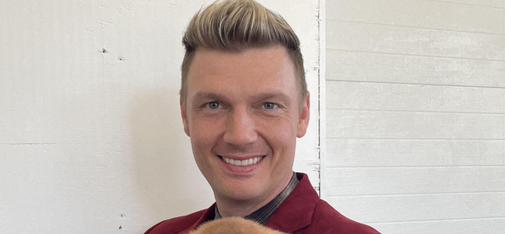 Nick Carter holding a puppy