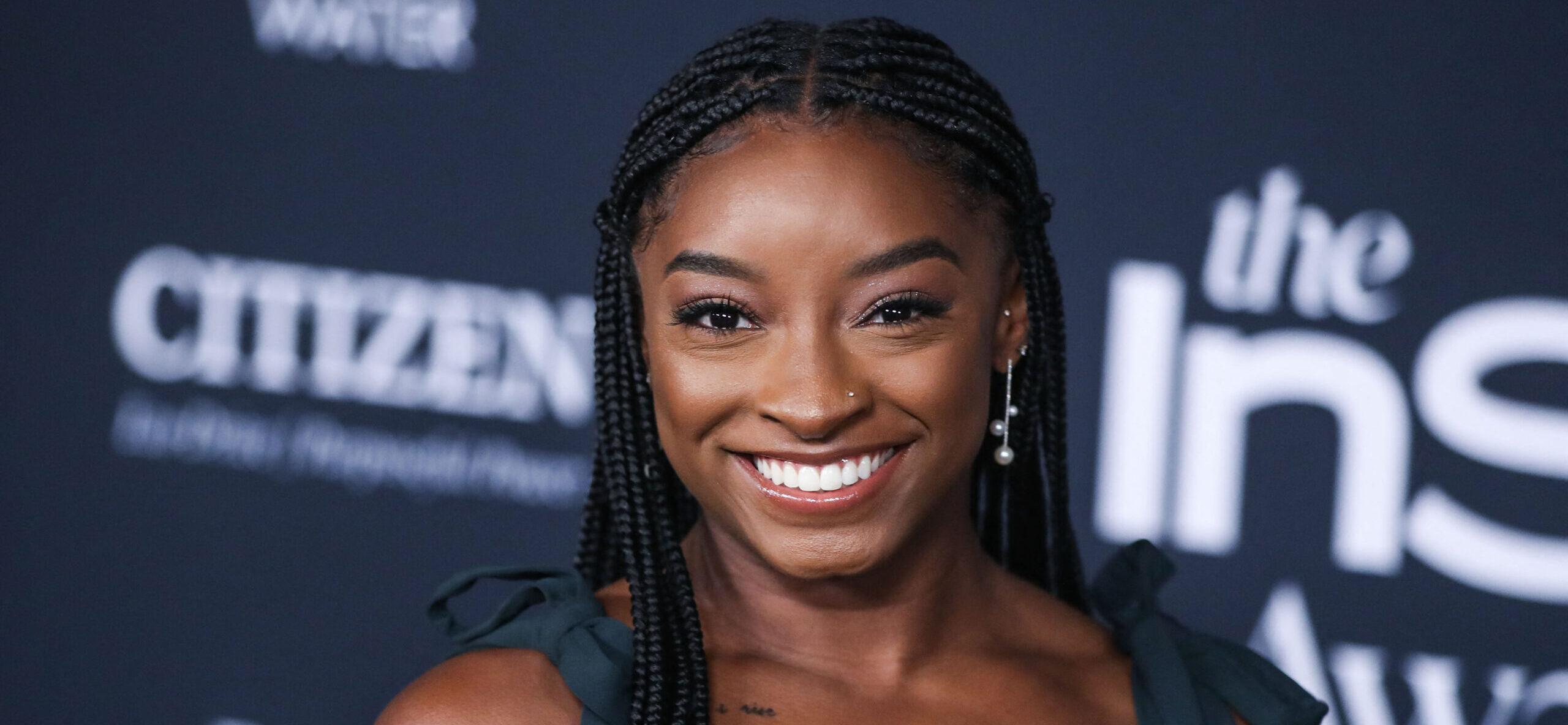 Simone Biles wearing an Aliette dress, Christian Louboutin shoes, and Matteo jewelry while carrying a Judith Leiber bag arrives at the 6th Annual InStyle Awards 2021